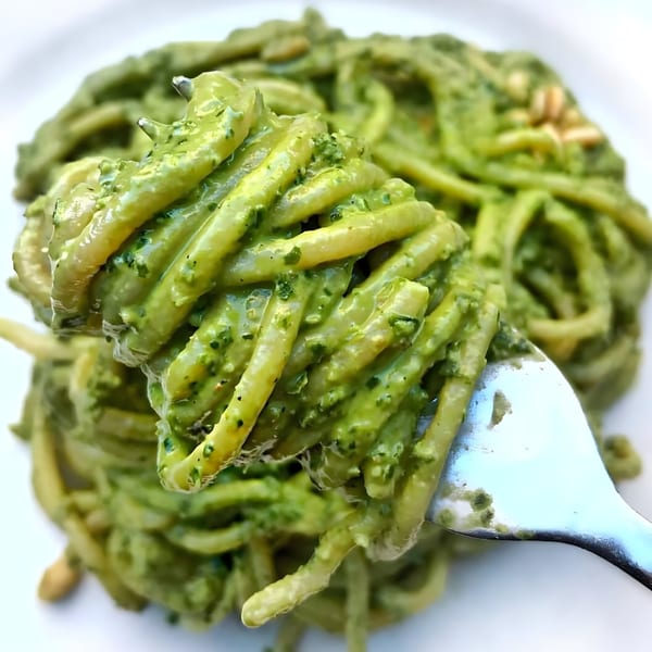 A fork lifts a generous portion of Franco's Italian Restaurant's pesto pasta with pine nuts.